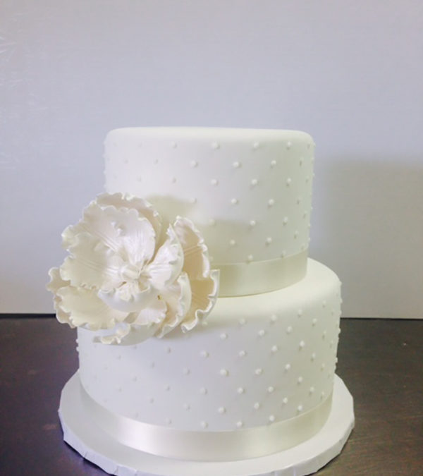 All White Dotted Wedding Cake with Accent Flower